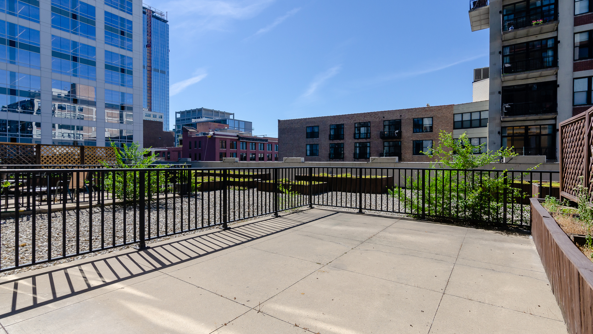210 South Desplaines Street, Unit 606 Chicago, IL 60661 - Photo 23 of 33 a view of a balcony with a floor to ceiling window and plants