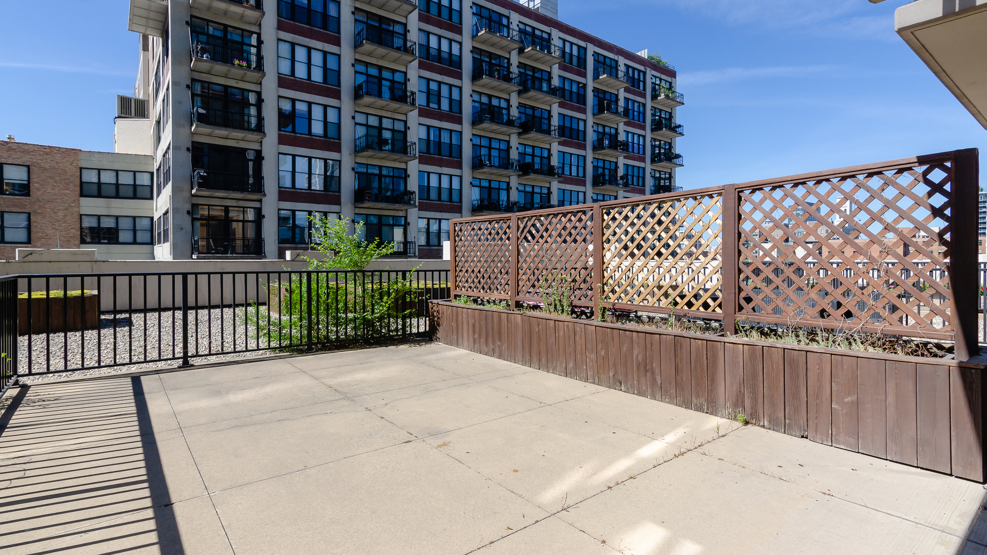 210 South Desplaines Street, Unit 606 Chicago, IL 60661 - Photo 25 of 33 a view of a balcony with wooden fence