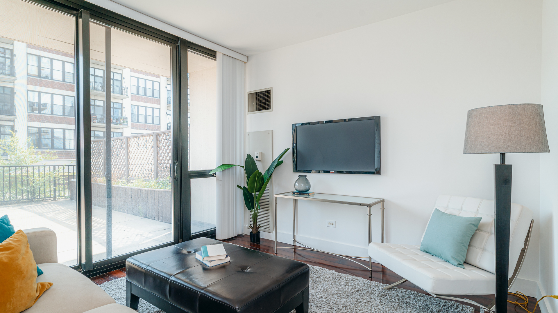 210 South Desplaines Street, Unit 606 Chicago, IL 60661 - Photo 7 of 33 a living room with furniture and a flat screen tv