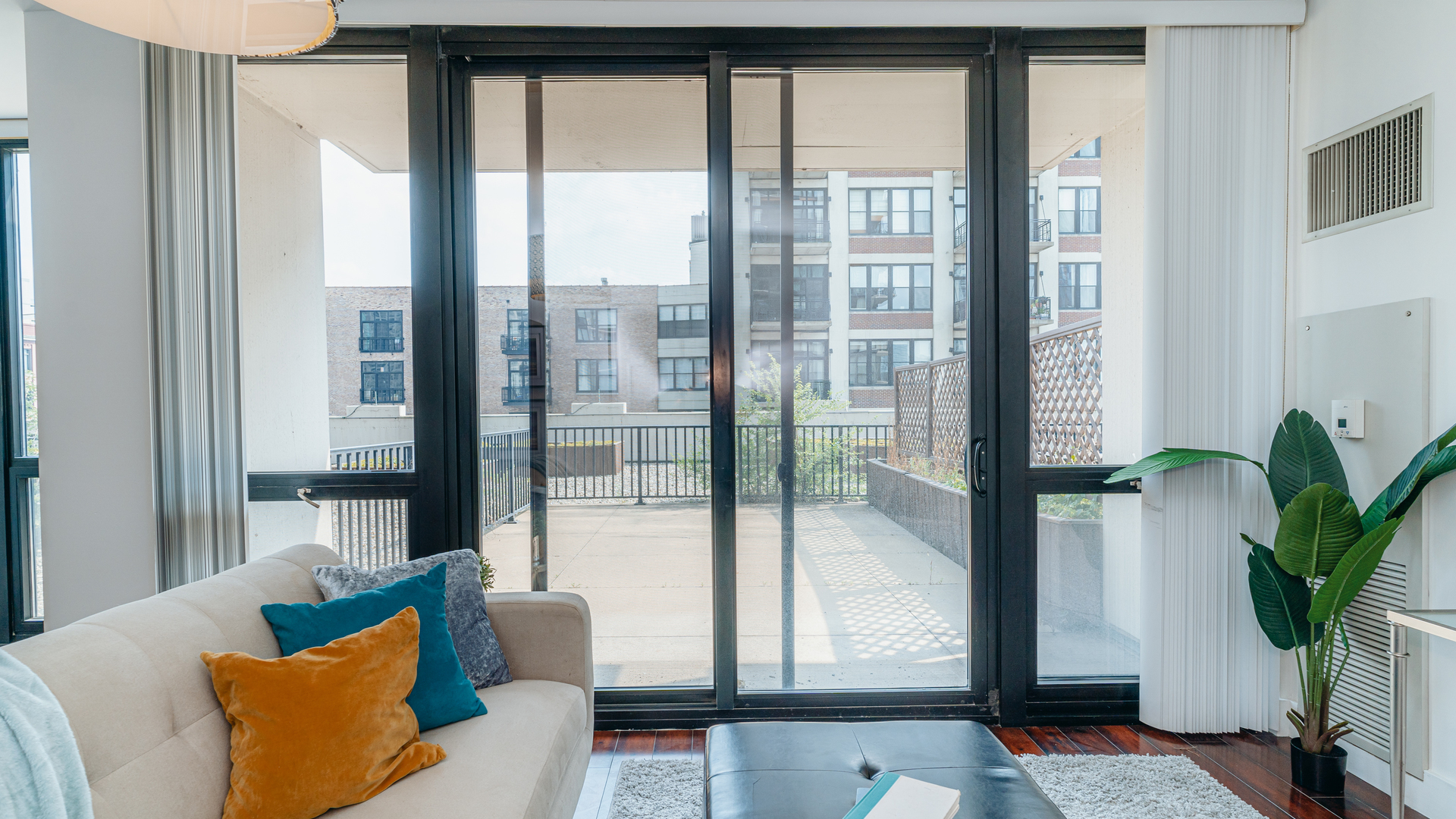 210 South Desplaines Street, Unit 606 Chicago, IL 60661 - Photo 8 of 33 a living room with furniture and a potted plant