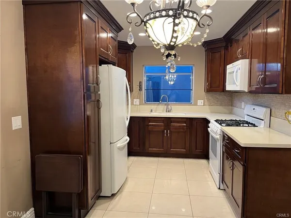 a kitchen with a stove a refrigerator and a sink