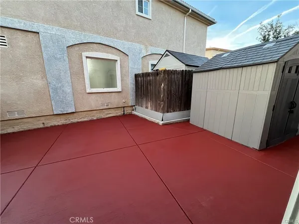 a view of a room with wooden walls and windows
