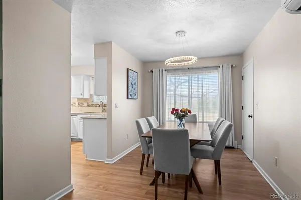 a view of a dining room with furniture wooden floor and a chandelier