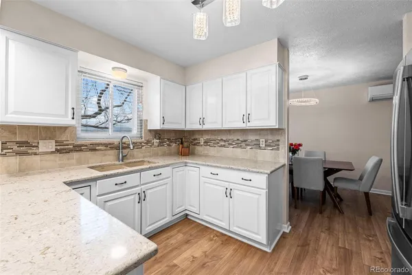 a kitchen with a sink cabinets and wooden floor