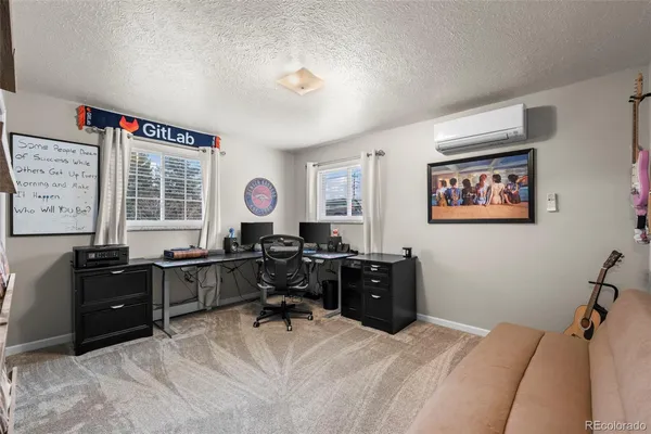 a view of a workspace with furniture and a window