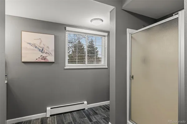 a view of small space with wooden floor and a window