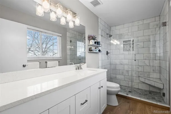 a bathroom with a sink a toilet and a mirror