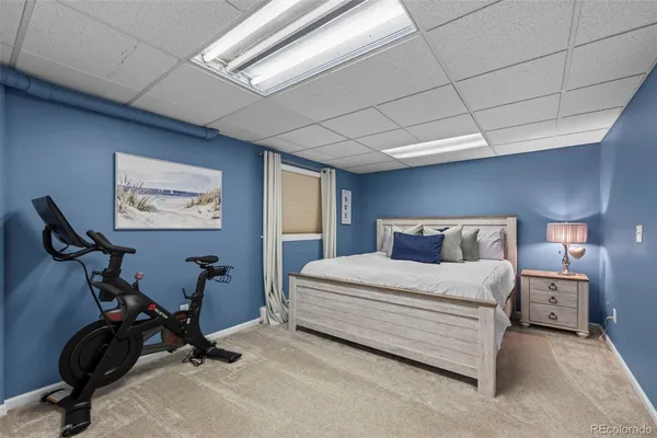 a bedroom with a bed a desk and chair