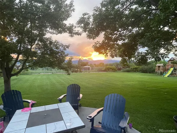a view of a table and chairs in the garden