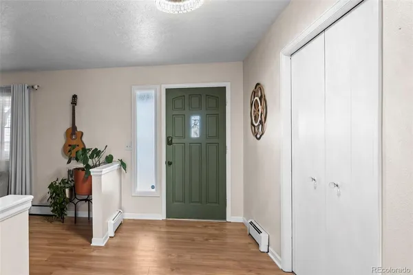 a view of an entryway with wooden floor