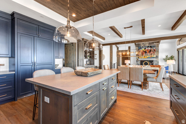 1282 Chimney Rock Road, Unit 344 Heber City, UT 84032 - Photo 20 of 55 Kitchen featuring a wood-panel ceiling, hardwood flooring, and a central island with a light-toned countertop