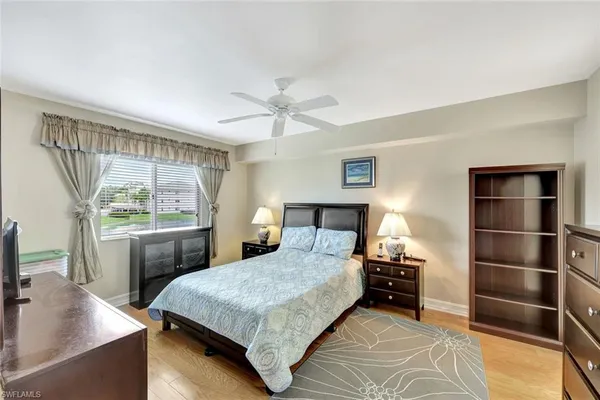 a bedroom with a large bed and a window