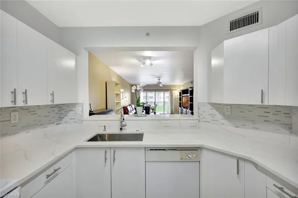 a kitchen with a sink and cabinets