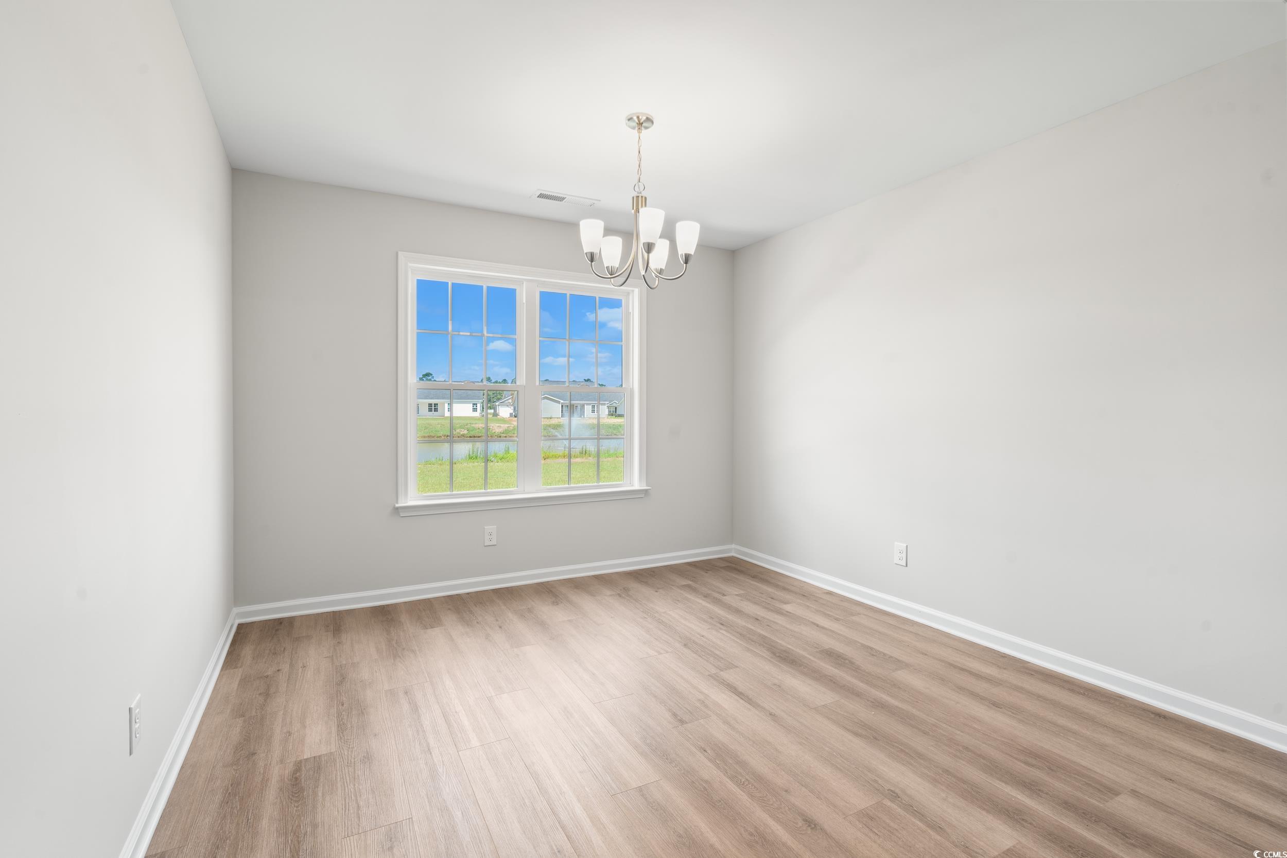 625 Woodside Drive Conway, SC 29526 - Photo 9 of 37 Spare room with a chandelier and light wood-style
