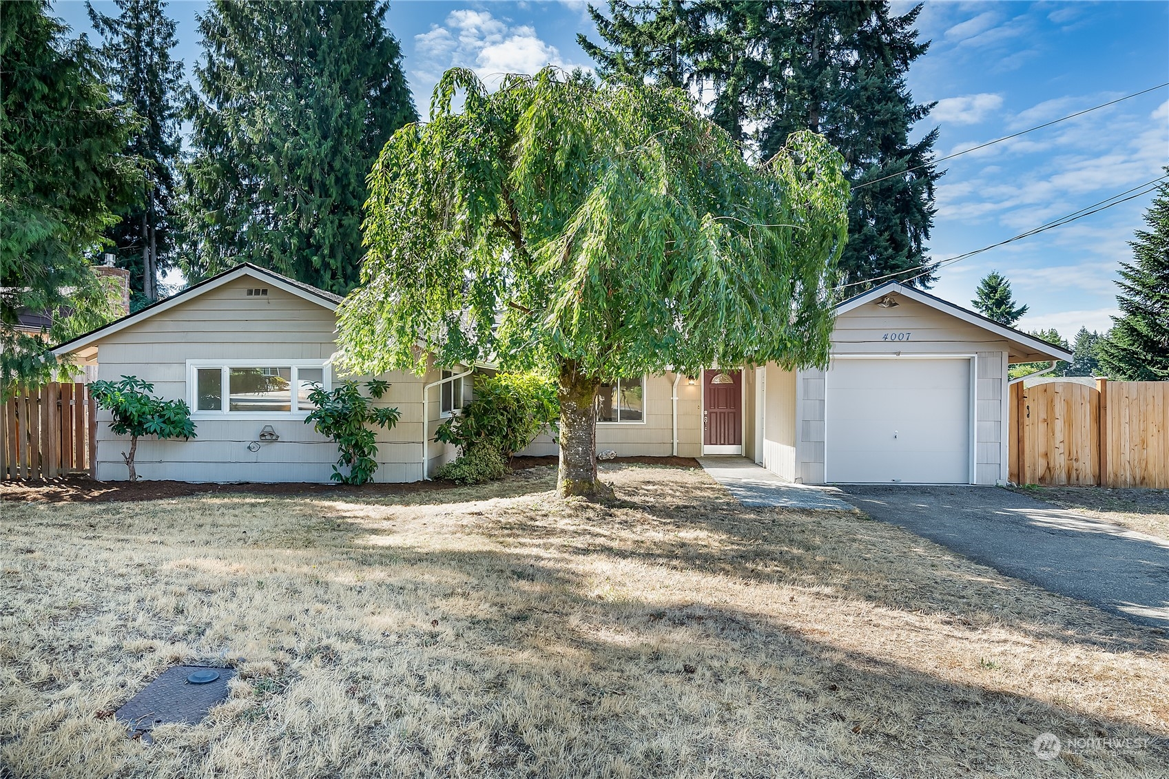 4007 Northeast 22nd Place Renton, WA 98056 - Photo 1 of 29 a view of a house with a yard and large tree