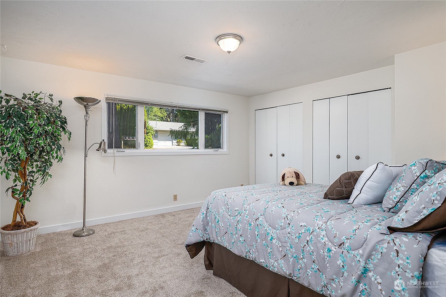 4007 Northeast 22nd Place Renton, WA 98056 - Photo 17 of 29 a bedroom with a bed and a potted plant