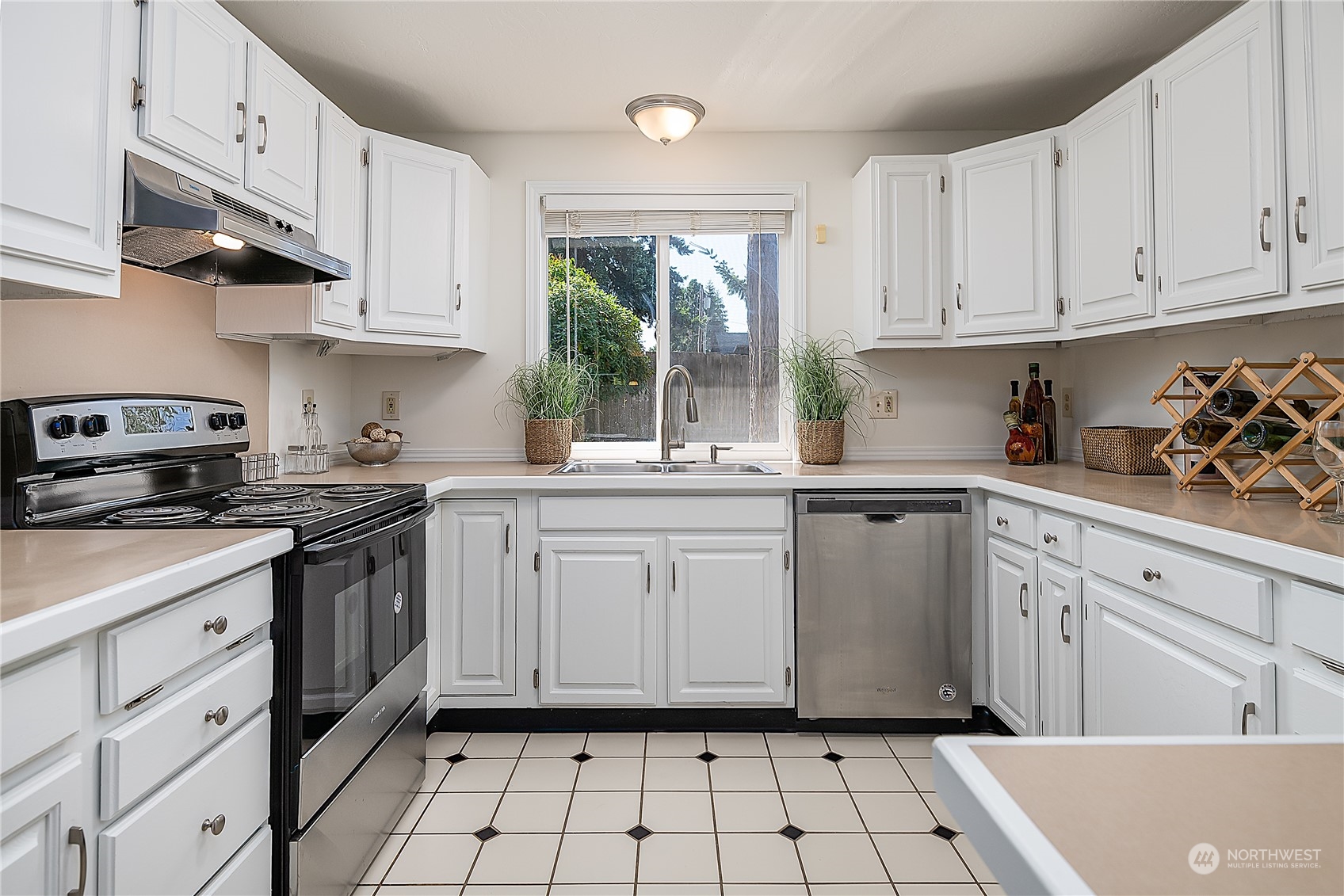 4007 Northeast 22nd Place Renton, WA 98056 - Photo 7 of 29 a kitchen with white cabinets and white appliances