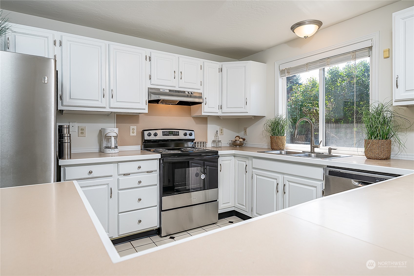 4007 Northeast 22nd Place Renton, WA 98056 - Photo 8 of 29 a kitchen with granite countertop white cabinets and white appliances