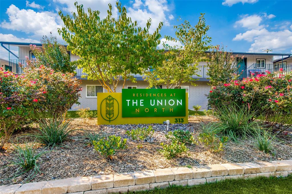2211 West Hickory Street, Unit B5R Denton, TX 76201 - Photo 1 of 14 a sign that is sitting in front of flowers