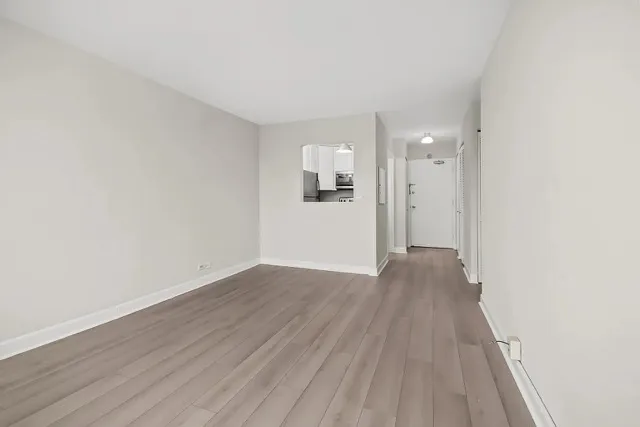 a view of a room with wooden floor