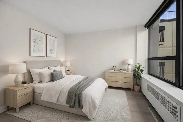 a bedroom with bed and window