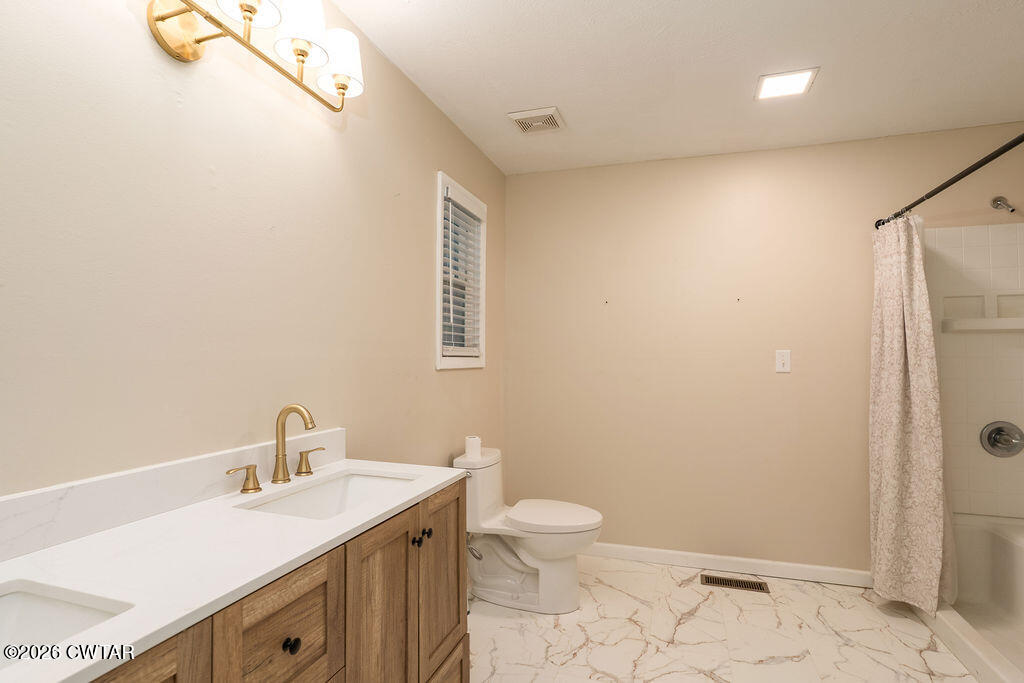 7 Timberlake Drive Jackson, TN 38305 - Photo 22 of 38 a bathroom with a sink a toilet and shower