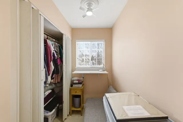 a view of walk in closet with clothes and shoes