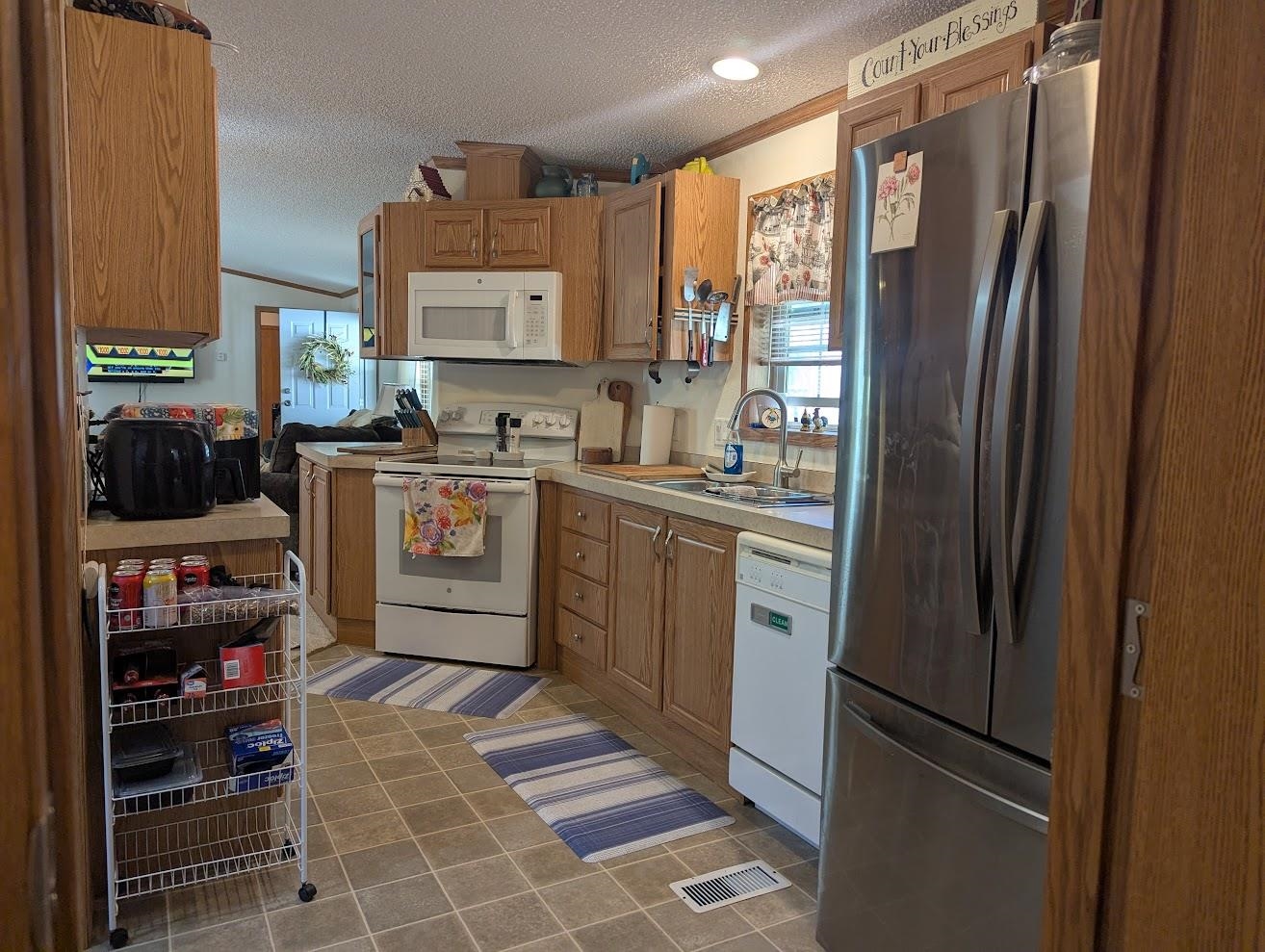 435 32 Road, Unit 628 Clifton, CO 81520 - Photo 2 of 31 a kitchen with stainless steel appliances granite countertop a refrigerator a sink a stove and a refrigerator