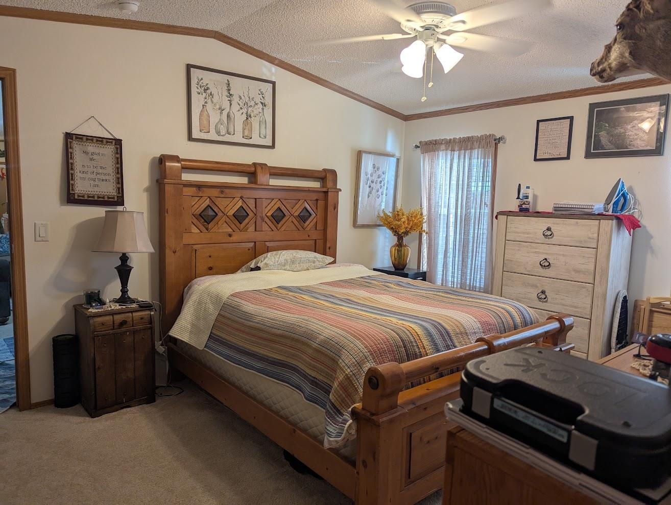 435 32 Road, Unit 628 Clifton, CO 81520 - Photo 22 of 31 a bedroom with a bed and a chandelier
