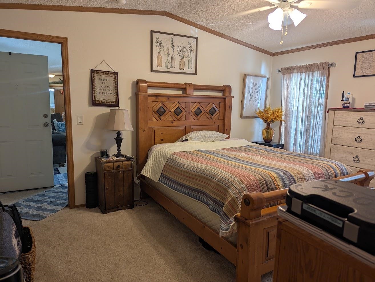 435 32 Road, Unit 628 Clifton, CO 81520 - Photo 23 of 31 a bedroom with a bed and a chandelier