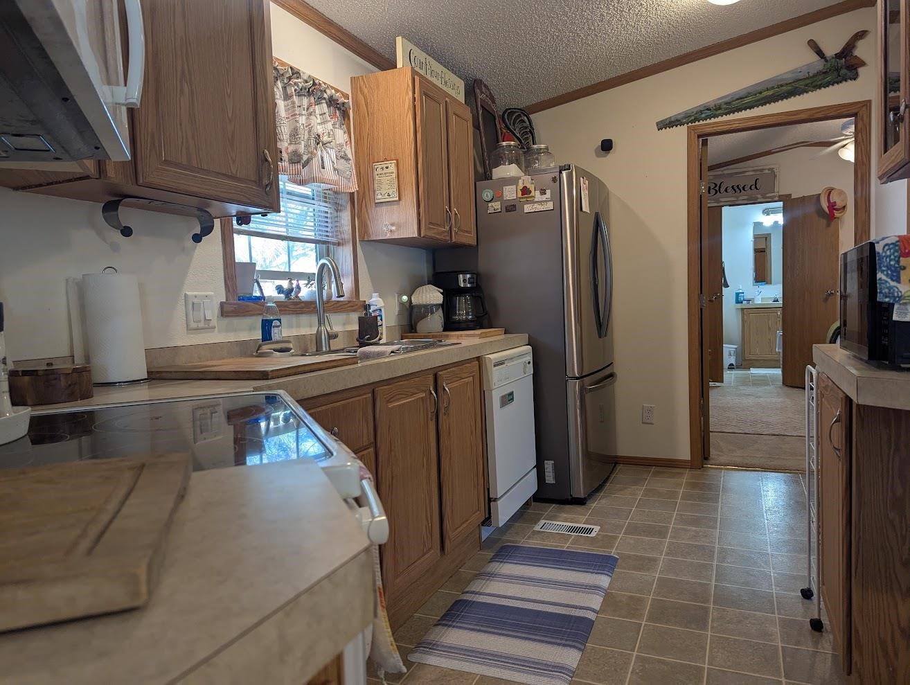 435 32 Road, Unit 628 Clifton, CO 81520 - Photo 6 of 31 a kitchen with stainless steel appliances granite countertop a sink stove and refrigerator