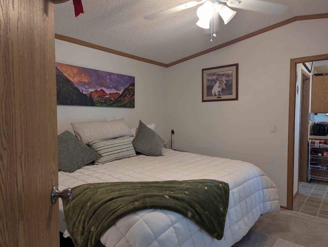 435 32 Road, Unit 628 Clifton, CO 81520 - Photo 9 of 31 a bedroom with a bed and a painting on the wall