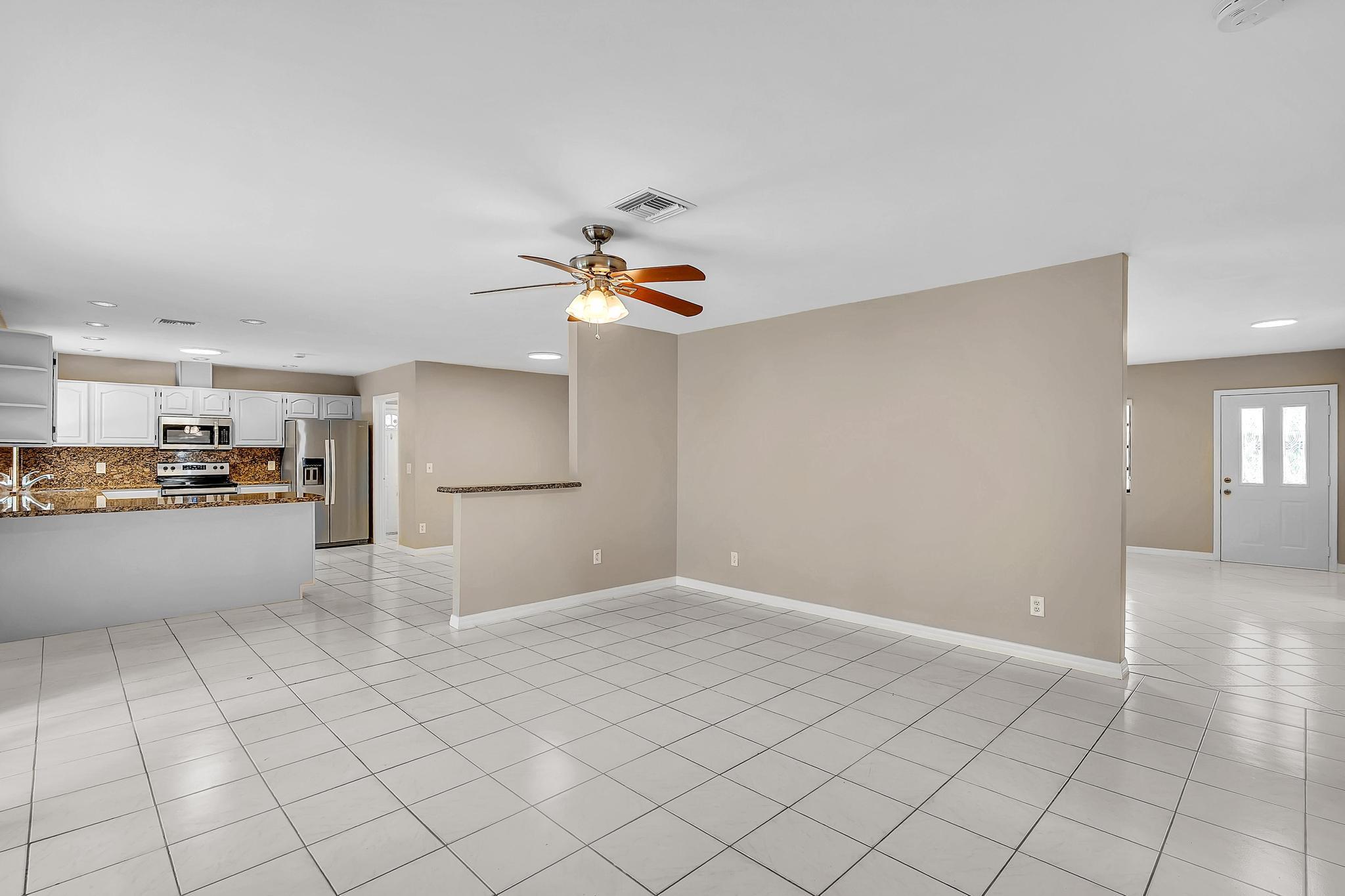 6144 Royal Lytham Drive Boca Raton, FL 33433 - Photo 13 of 70 a view of a kitchen with furniture and an empty room