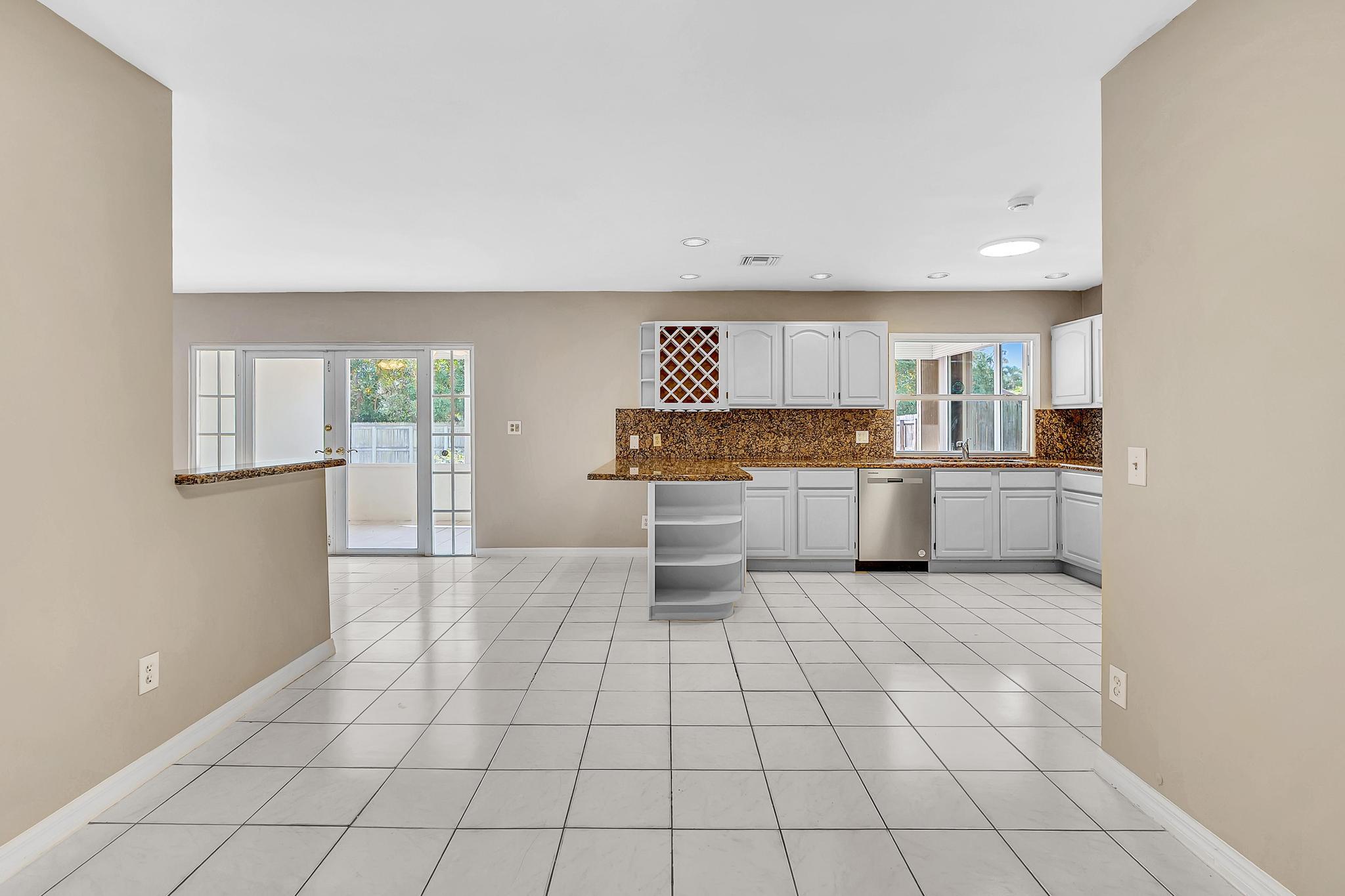 6144 Royal Lytham Drive Boca Raton, FL 33433 - Photo 20 of 70 a large white kitchen with a stove a sink and a refrigerator
