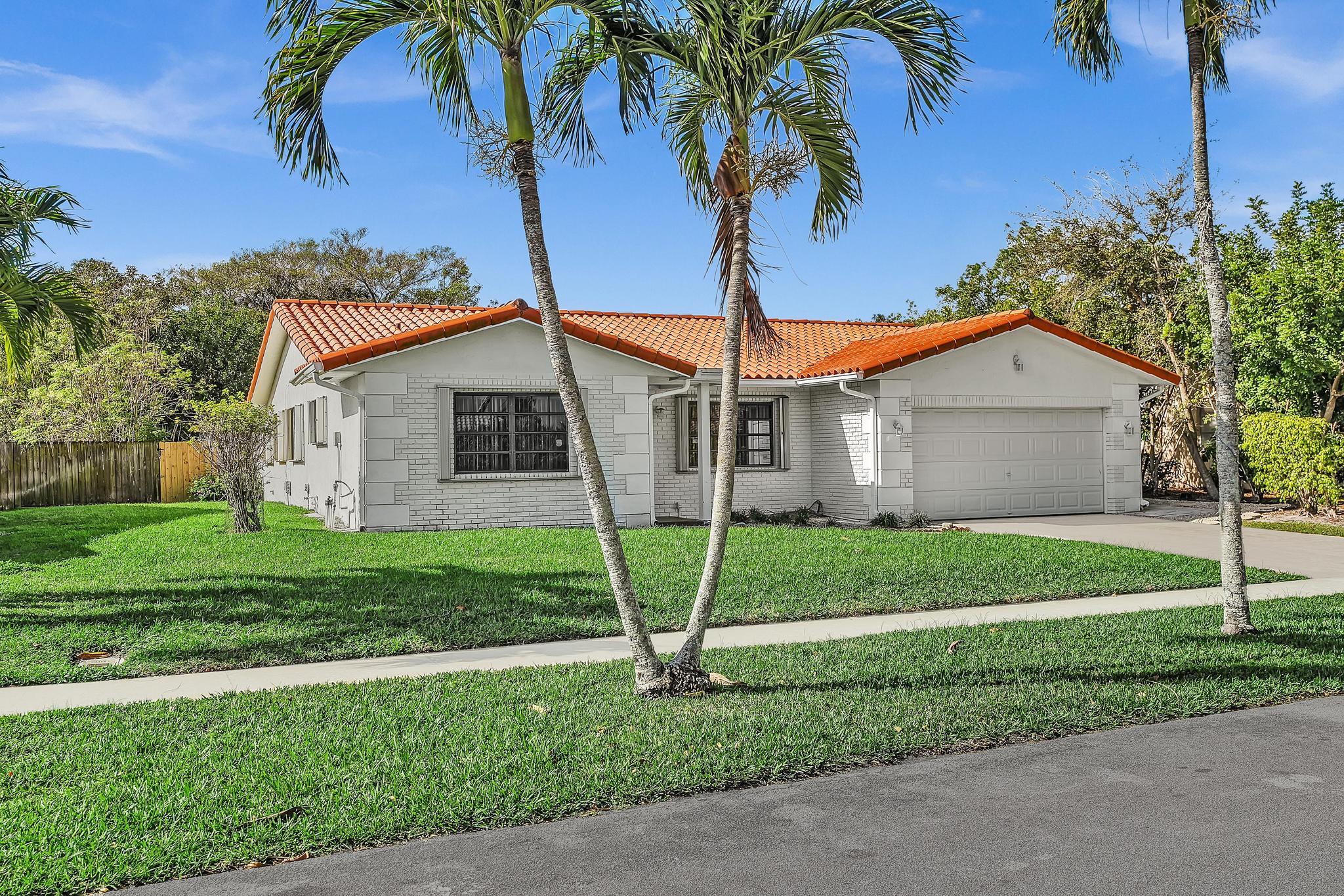 6144 Royal Lytham Drive Boca Raton, FL 33433 - Photo 2 of 70 a view of a house with a yard and palm trees