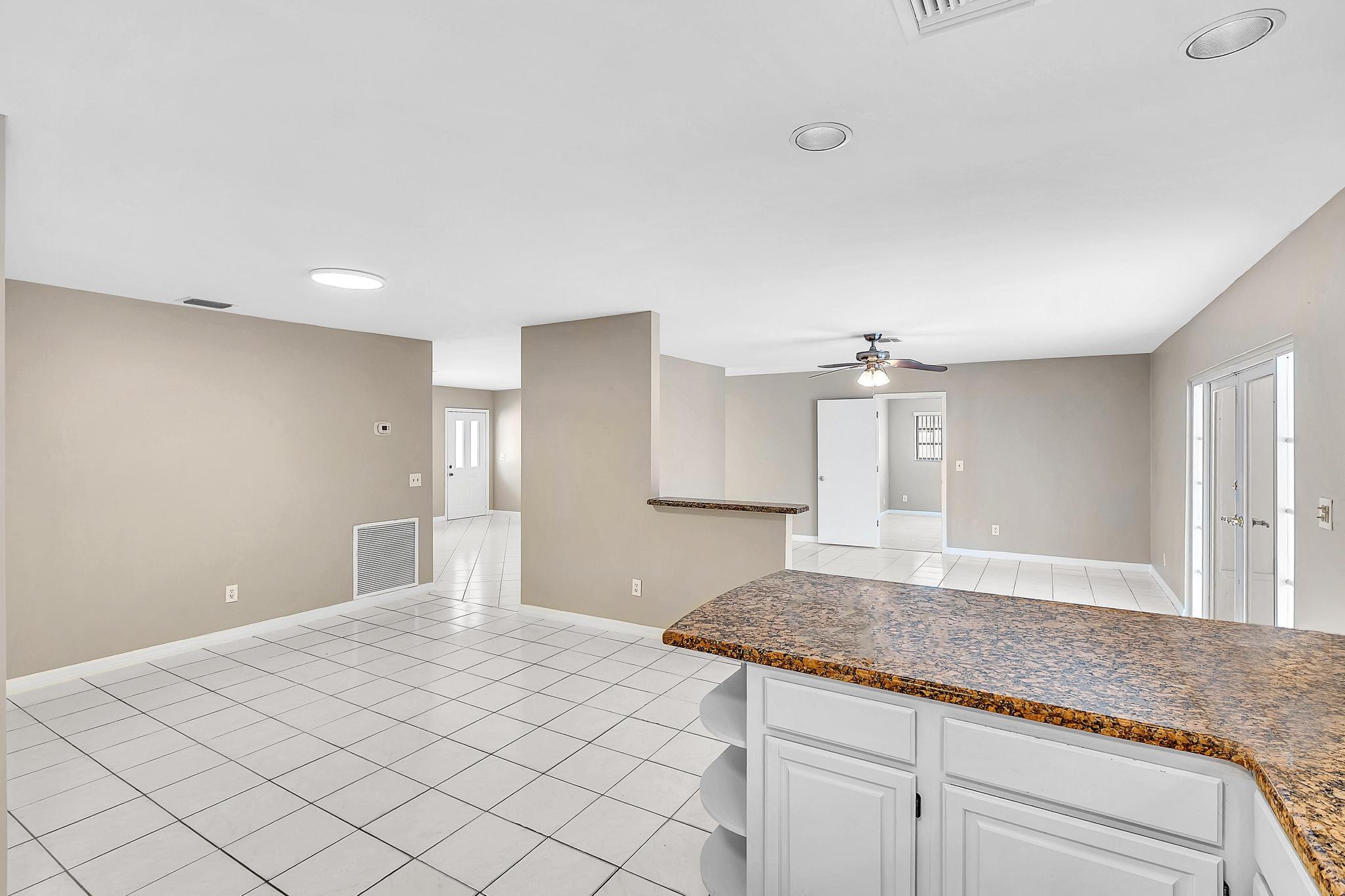 6144 Royal Lytham Drive Boca Raton, FL 33433 - Photo 23 of 70 a spacious bathroom with a granite countertop sink and a mirror