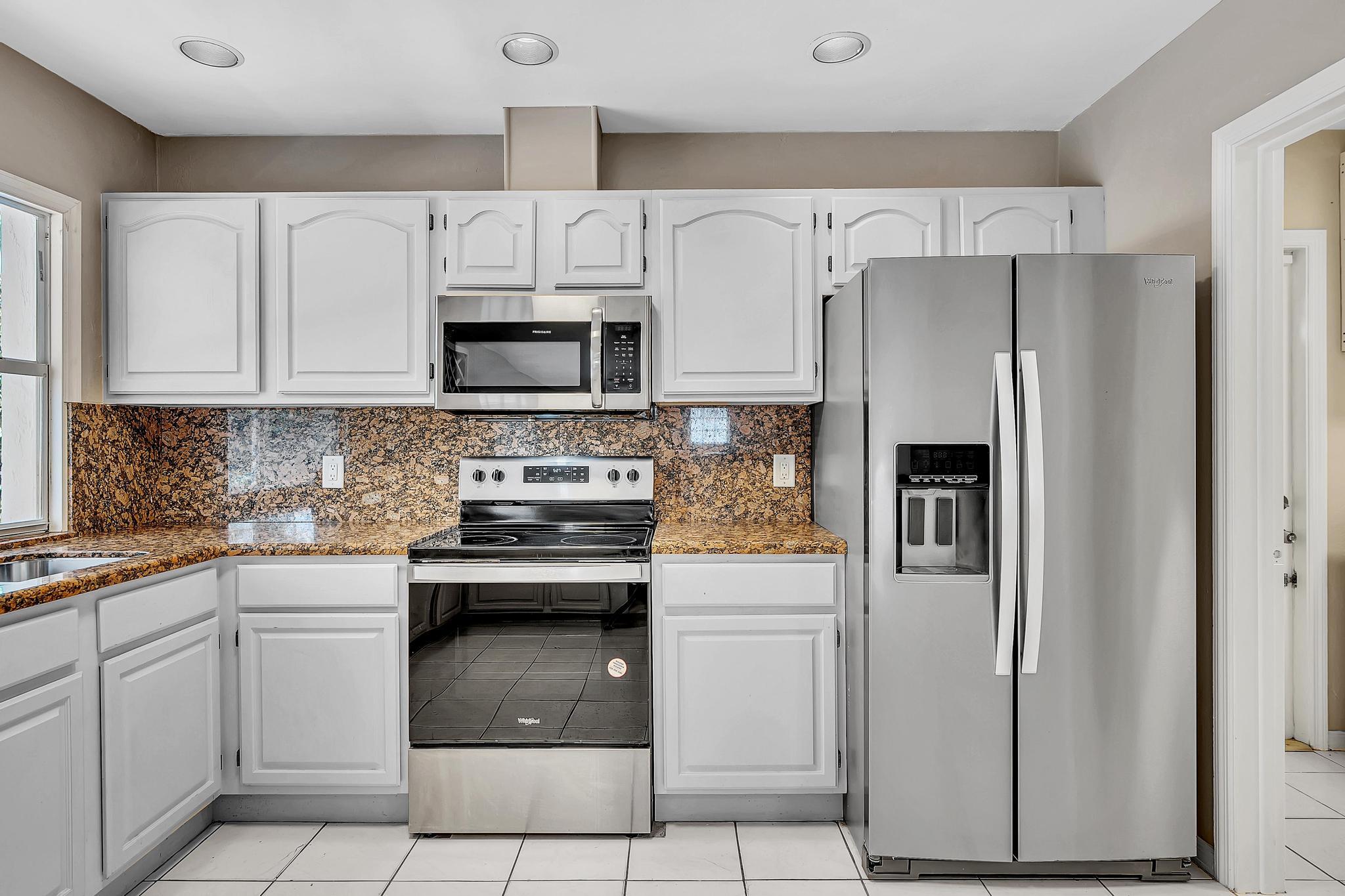 6144 Royal Lytham Drive Boca Raton, FL 33433 - Photo 24 of 70 a kitchen with cabinets stainless steel appliances and a counter space
