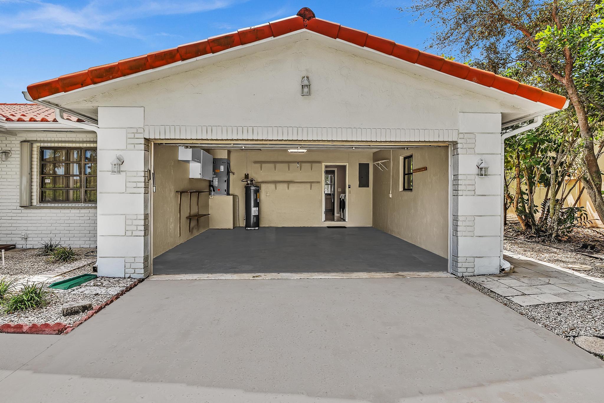 6144 Royal Lytham Drive Boca Raton, FL 33433 - Photo 27 of 70 a front view of a house with a yard and garage