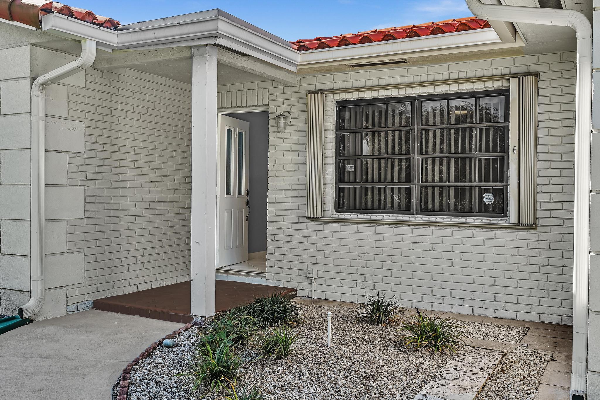 6144 Royal Lytham Drive Boca Raton, FL 33433 - Photo 5 of 70 a front view of a house