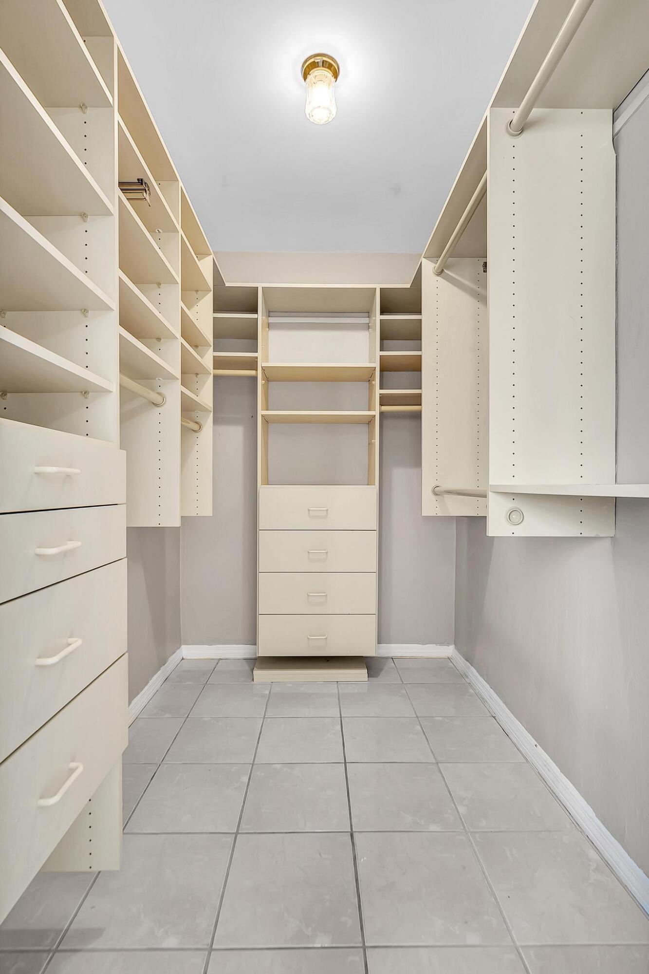 6144 Royal Lytham Drive Boca Raton, FL 33433 - Photo 51 of 70 a view of walk in closet with empty racks