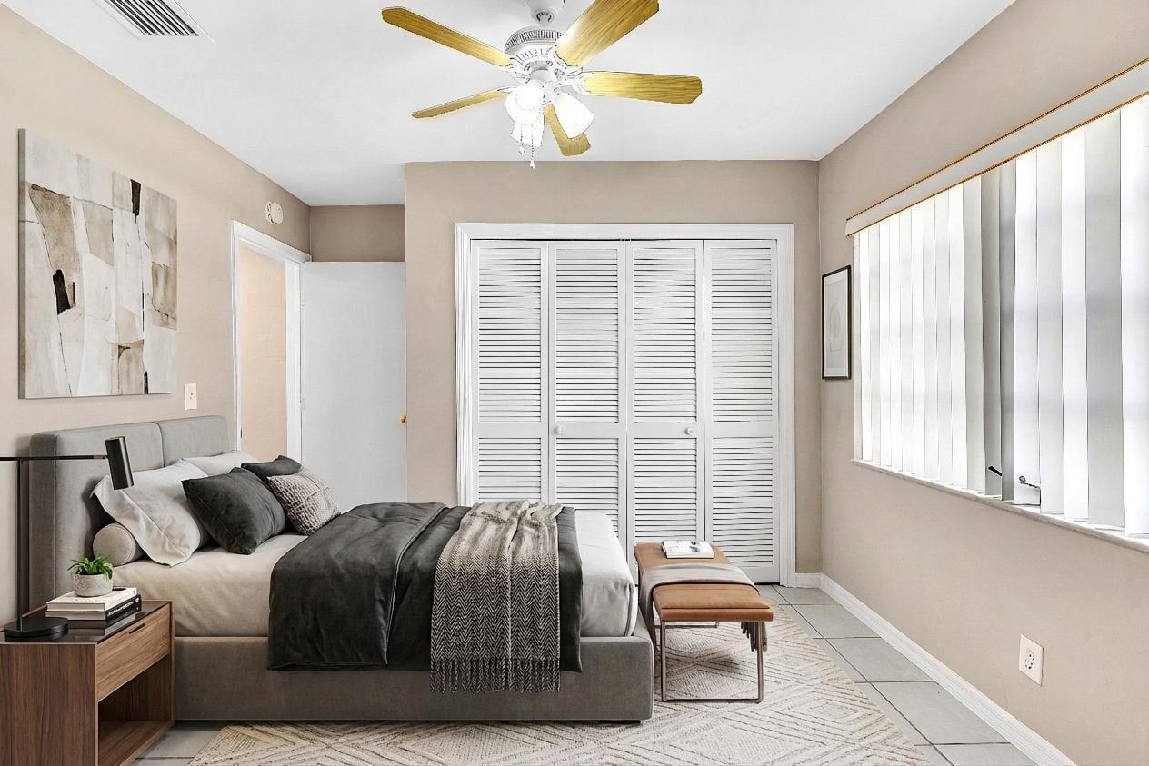 6144 Royal Lytham Drive Boca Raton, FL 33433 - Photo 63 of 70 a bedroom with furniture and a large window