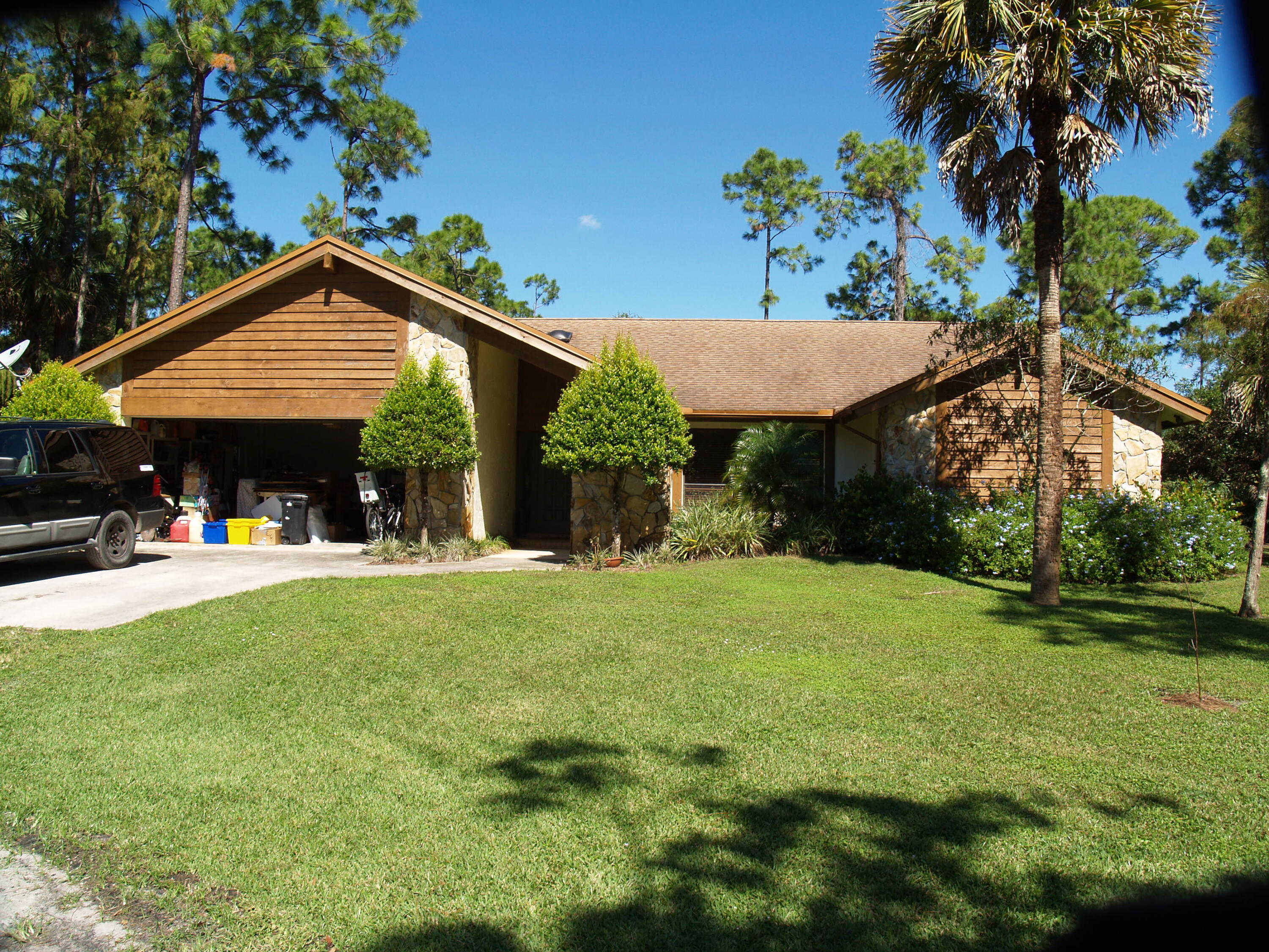 6815 Monmouth Road West Palm Beach, FL 33413 - Photo 3 of 6 a view of a house with a yard and sitting area