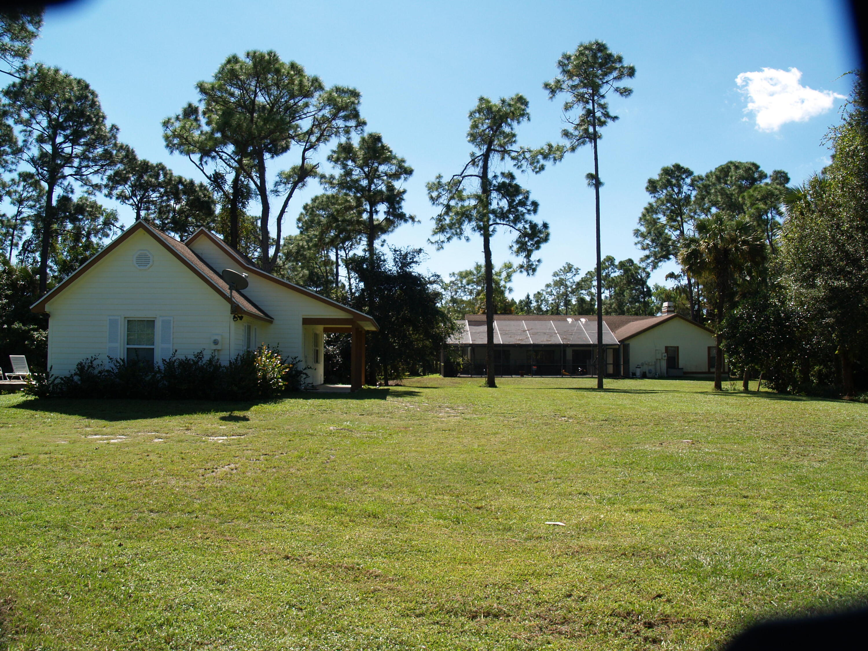 6815 Monmouth Road West Palm Beach, FL 33413 - Photo 6 of 6 a front view of house with yard and trees in the background