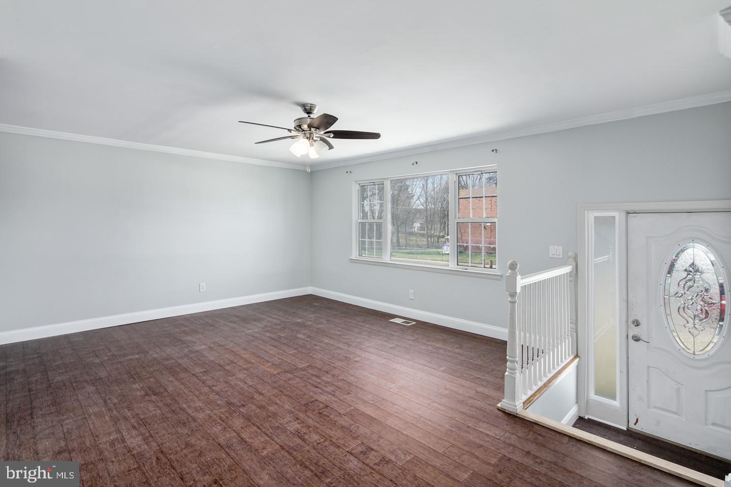 12519 Medford Road Philadelphia, PA 19154 - Photo 13 of 20 a view of an empty room with wooden floor and a window