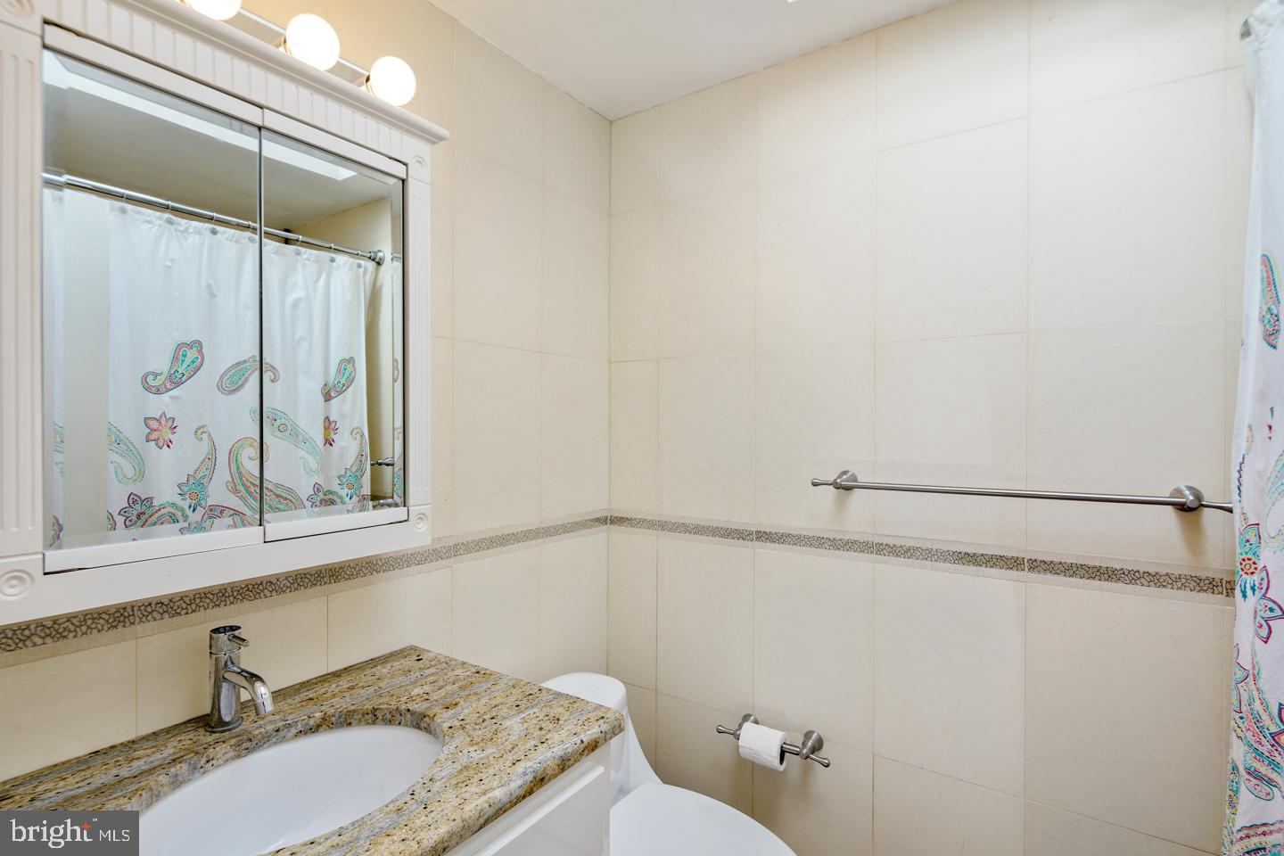 12519 Medford Road Philadelphia, PA 19154 - Photo 14 of 20 a bathroom with a granite countertop sink and a mirror