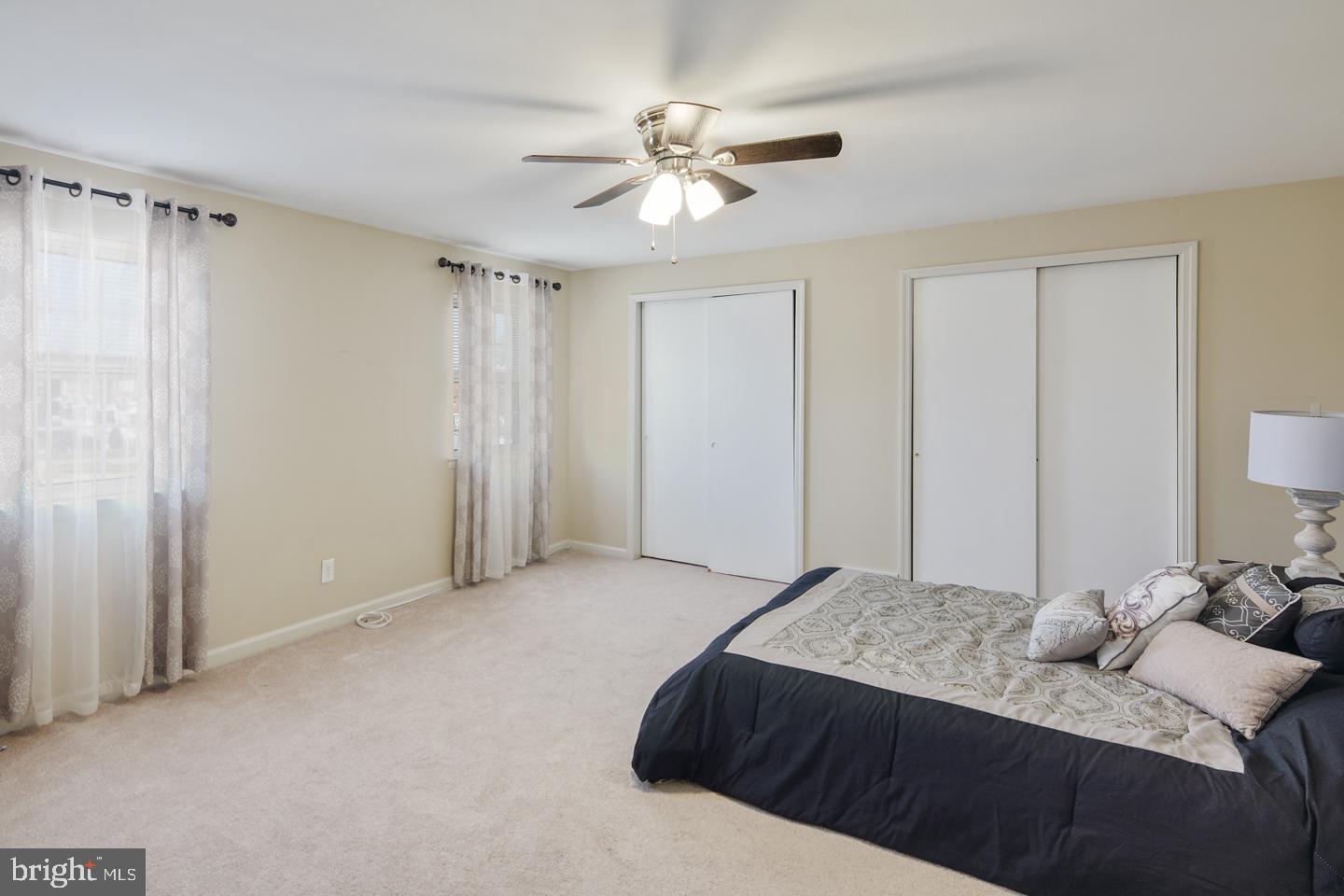12519 Medford Road Philadelphia, PA 19154 - Photo 17 of 20 a bedroom with a large bed and a chandelier