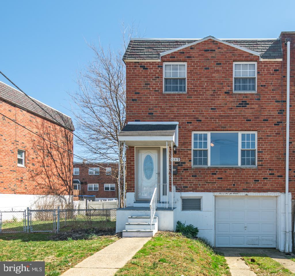 12519 Medford Road Philadelphia, PA 19154 - Photo 20 of 20 front view of a brick house with a yard
