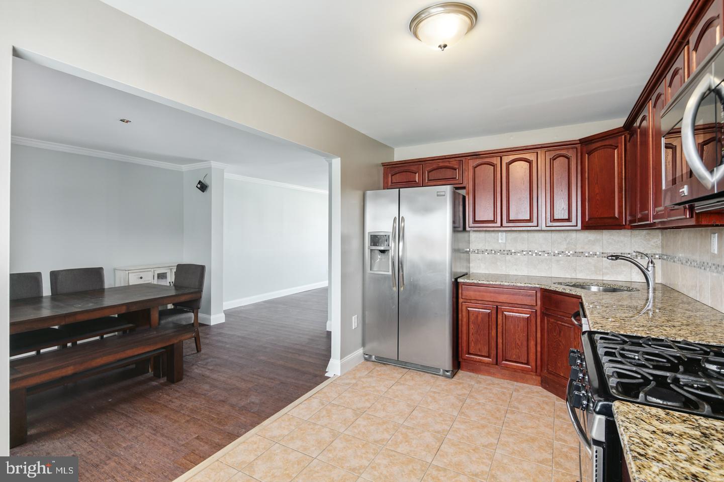 12519 Medford Road Philadelphia, PA 19154 - Photo 6 of 20 a kitchen with stainless steel appliances granite countertop a refrigerator and a stove top oven
