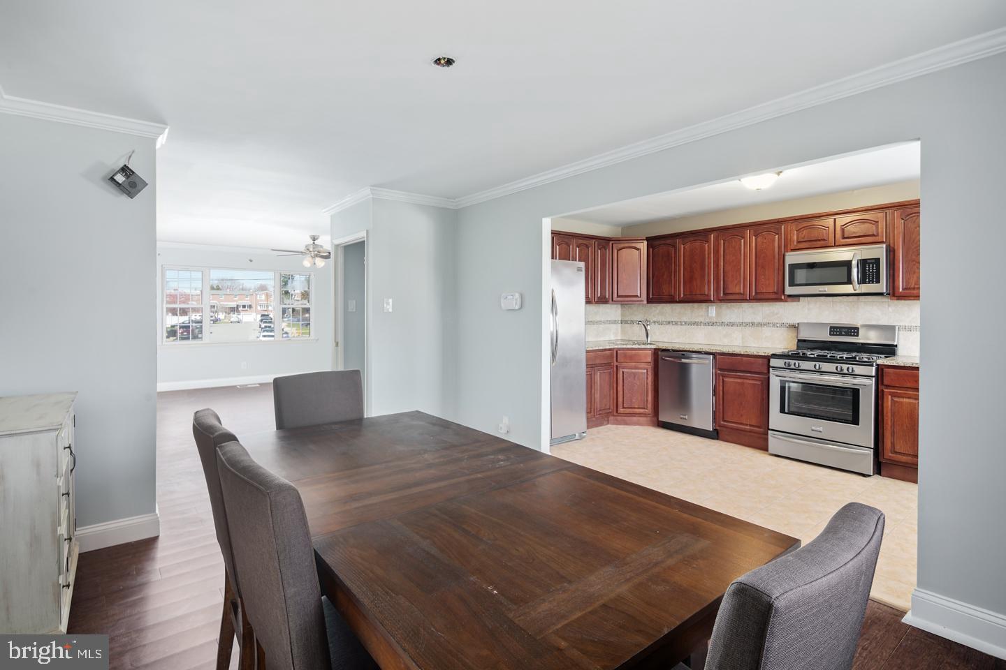 12519 Medford Road Philadelphia, PA 19154 - Photo 10 of 20 a open dining room with stainless steel appliances a dining table and chairs