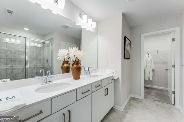 a bathroom with a sink double vanity granite tub and shower